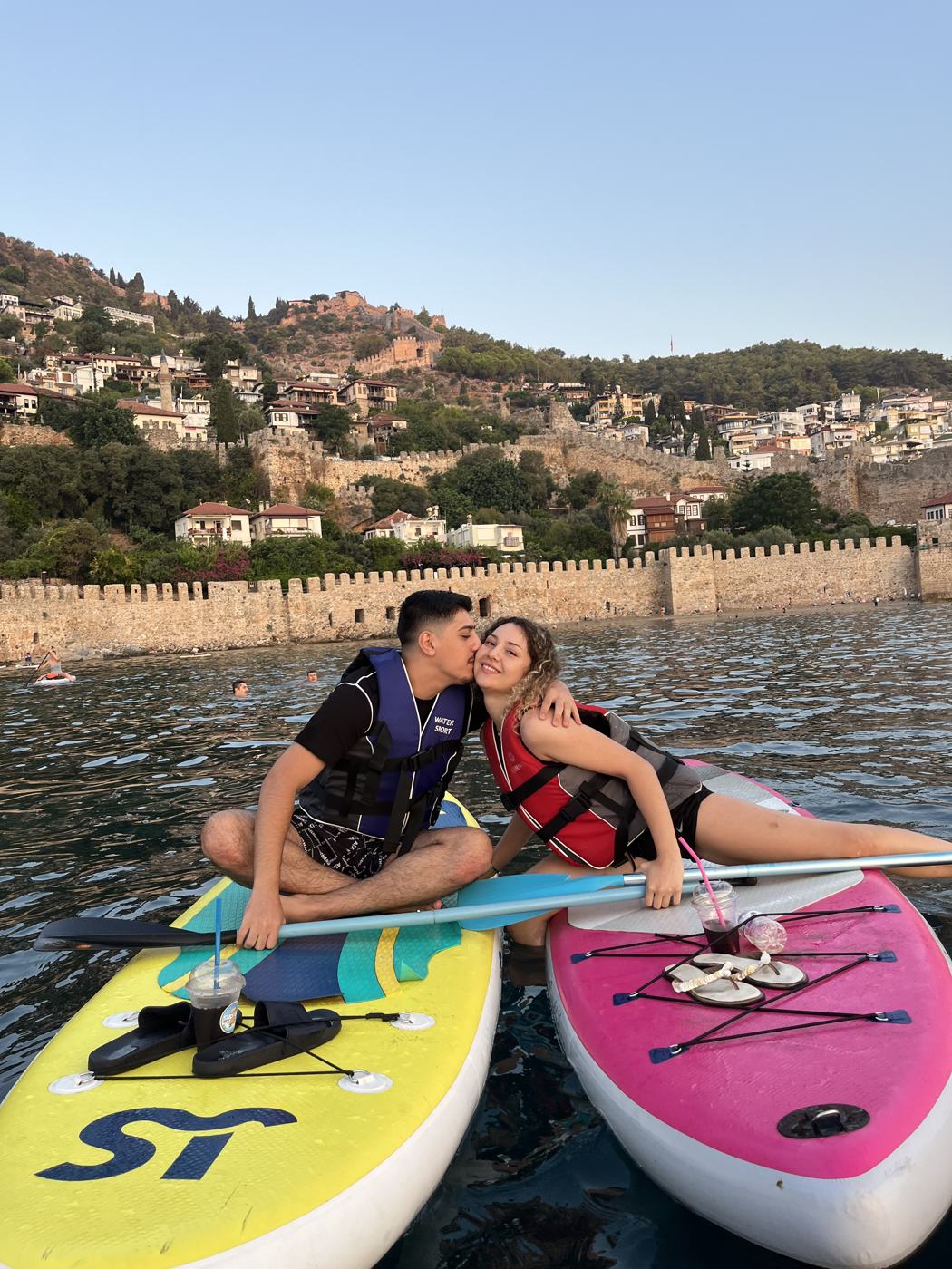 Couple posing on their boards on the water