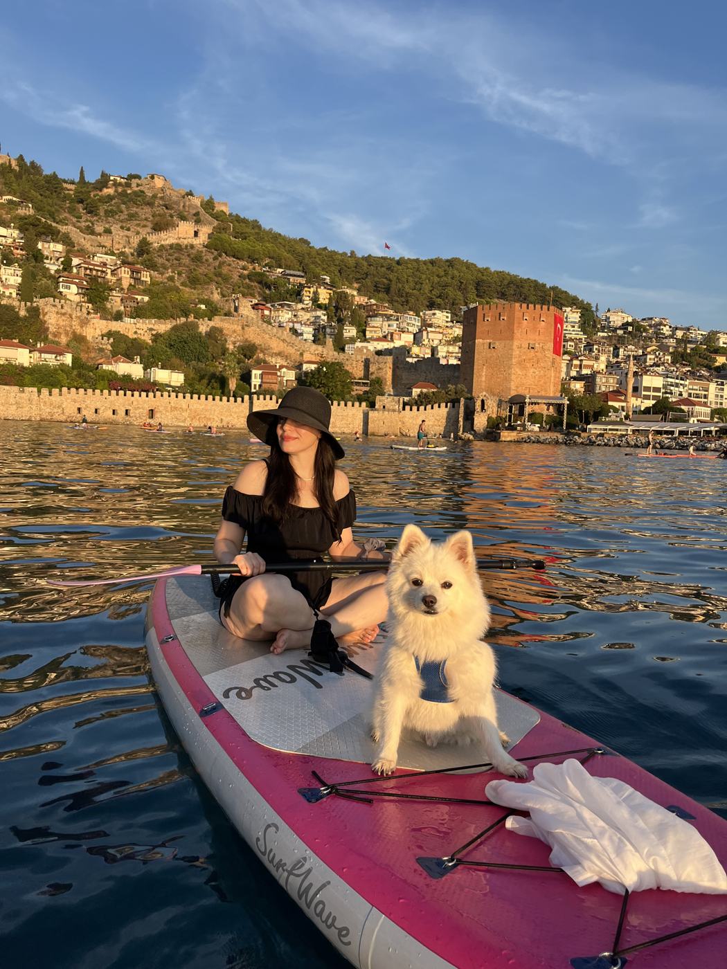 Guest and a white dog sharing a board near the Red Tower